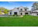 Modern two-story home with white siding, black windows, and a well-manicured lawn at 2059 Mozelle Dr, Marietta, GA 30062