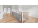 Upstairs hallway featuring hardwood floors and wrought iron railing at 2059 Mozelle Dr, Marietta, GA 30062