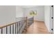 Upstairs hallway featuring hardwood floors and wrought iron railing at 2059 Mozelle Dr, Marietta, GA 30062