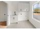 Functional laundry room with shaker cabinets, utility sink and a window at 2059 Mozelle Dr, Marietta, GA 30062