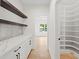 Walk-in pantry with custom shelving and white countertops, next to an adjacent room at 2059 Mozelle Dr, Marietta, GA 30062