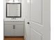Modern powder room with a sleek vanity, marble countertop, and designer mirror at 2059 Mozelle Dr, Marietta, GA 30062