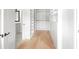 Spacious walk-in closet with custom shelving and drawers, adjacent to a bathroom at 2059 Mozelle Dr, Marietta, GA 30062