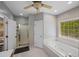 Well-lit bathroom with a soaking tub, a separate shower, and a double-sink vanity at 215 The Farm Rd, Mcdonough, GA 30252