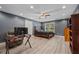Spacious bedroom with gray walls, wood-look floors, ceiling fan, and abundant natural light at 215 The Farm Rd, Mcdonough, GA 30252