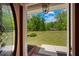 Welcoming entrance with a view of the lush front yard and a glimpse of the beautiful home at 215 The Farm Rd, Mcdonough, GA 30252