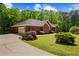 Stunning exterior view of the home with a spacious driveway and lush greenery at 215 The Farm Rd, Mcdonough, GA 30252