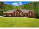 Charming brick home featuring a well-manicured lawn and traditional architectural details at 215 The Farm Rd, Mcdonough, GA 30252