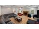 Spacious living room with a cozy fireplace, comfortable seating, and ample natural light at 215 The Farm Rd, Mcdonough, GA 30252