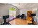Bright interior space features a large window, light wood floors, chandelier, and home office set up at 215 The Farm Rd, Mcdonough, GA 30252