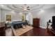Bright main bedroom with a tray ceiling, ample natural light, and hardwood floors at 215 The Farm Rd, Mcdonough, GA 30252