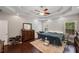Comfortable main bedroom featuring a tray ceiling, hardwood floors, and plentiful natural light at 215 The Farm Rd, Mcdonough, GA 30252