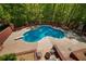 Stunning aerial view of the private backyard pool with a diving board at 215 The Farm Rd, Mcdonough, GA 30252