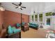 Covered porch with brick wall, ceiling fans and comfortable seating area overlooking pool at 215 The Farm Rd, Mcdonough, GA 30252
