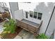 Backyard view featuring a small deck and white fence, with a downstairs garage for convenience at 3409 Catalan Aly, Decatur, GA 30032