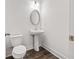 Modern powder room with pedestal sink, oval mirror, and clean, minimalist design at 3409 Catalan Aly, Decatur, GA 30032