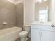 Clean bathroom featuring tub, tile accents, a sink with vanity, and modern fixtures at 3409 Catalan Aly, Decatur, GA 30032