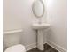 Neat bathroom features a modern pedestal sink, toilet and neutral decor, maximizing space in a compact design at 3409 Catalan Aly, Decatur, GA 30032