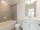 Clean bathroom with a shower-tub combo, tile surround, and a white vanity for a fresh feel at 3409 Catalan Aly, Decatur, GA 30032