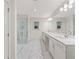 Bathroom featuring double sink vanity, glass shower and white marble floors at 3409 Catalan Aly, Decatur, GA 30032