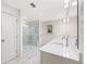 Bathroom featuring double sink vanity, glass shower and white marble floors at 3409 Catalan Aly, Decatur, GA 30032