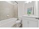 Neutral, updated bathroom featuring a combination tub and shower, a white vanity, and modern fixtures at 3409 Catalan Aly, Decatur, GA 30032