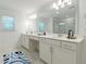 Bright bathroom featuring double vanity, large mirrors, and stylish marble flooring at 3409 Catalan Aly, Decatur, GA 30032