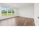 This bedroom has hardwood floors, a large window overlooking the yard, and fresh, neutral paint at 3409 Catalan Aly, Decatur, GA 30032