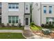 Charming townhome with light brick facade, manicured landscaping, and convenient walkway to the front door at 3409 Catalan Aly, Decatur, GA 30032