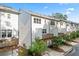 Exterior shot of townhomes displaying their private decks and garage parking nestled amongst the lush greenery at 3409 Catalan Aly, Decatur, GA 30032