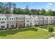Attractive townhome row with brick and siding details, complemented by manicured lawn at 3409 Catalan Aly, Decatur, GA 30032