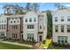 Attractive townhome exterior showcases brick and siding details, complemented by manicured landscaping at 3409 Catalan Aly, Decatur, GA 30032