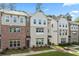 A row of attractive brick and siding townhomes is complemented by manicured front lawns at 3409 Catalan Aly, Decatur, GA 30032