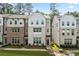 Charming townhome exterior with brick and siding details, enhanced by lush front lawn at 3409 Catalan Aly, Decatur, GA 30032