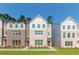 Charming multi-story townhomes showcasing brick and white siding with a well-maintained lawn at 3409 Catalan Aly, Decatur, GA 30032