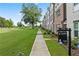 Exterior view showing a long green lawn with a walking path and 'For Sale' sign visible at 3409 Catalan Aly, Decatur, GA 30032