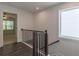 Upstairs hallway with modern black railing, a large window, and an open view to the living space, promoting natural light at 3409 Catalan Aly, Decatur, GA 30032