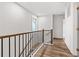 Hallway featuring hardwood floors, stairs with iron spindles, and a window at 3409 Catalan Aly, Decatur, GA 30032