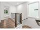 Hallway featuring hardwood floors, stairs, and a window for natural light at 3409 Catalan Aly, Decatur, GA 30032