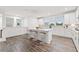 Modern kitchen features a large island with seating, white cabinetry, and stainless steel appliances at 3409 Catalan Aly, Decatur, GA 30032