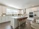 Modern kitchen features stainless steel appliances, an island with bar stools, and ample counter space with bright, natural light at 3409 Catalan Aly, Decatur, GA 30032