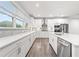 Modern kitchen with white cabinets, stainless steel appliances, herringbone backsplash, and a large window at 3409 Catalan Aly, Decatur, GA 30032