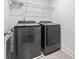 Laundry room featuring dark gray washer and dryer, and a wire rack at 3409 Catalan Aly, Decatur, GA 30032