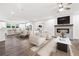 Open concept living space featuring a fireplace, kitchen with island, dining area, and comfortable seating at 3409 Catalan Aly, Decatur, GA 30032