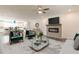 Open-concept living room with a fireplace, modern furnishings, and a view into the adjacent kitchen and dining area at 3409 Catalan Aly, Decatur, GA 30032