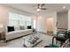 Inviting living room with large windows, comfortable seating, and a stylish glass coffee table on top of a patterned rug at 3409 Catalan Aly, Decatur, GA 30032