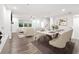 Open concept living and dining area with modern furnishings, a fireplace, and plenty of natural light at 3409 Catalan Aly, Decatur, GA 30032