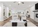 Bright and airy living room with contemporary furnishings, fireplace, and open access to the kitchen and dining area at 3409 Catalan Aly, Decatur, GA 30032