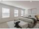 Bright main bedroom with three windows, neutral colors, and a seating area with plush furnishings for relaxation at 3409 Catalan Aly, Decatur, GA 30032