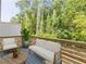 Serene patio showcases comfortable seating and a table, framed by a lush green forest backdrop for outdoor relaxation at 3409 Catalan Aly, Decatur, GA 30032